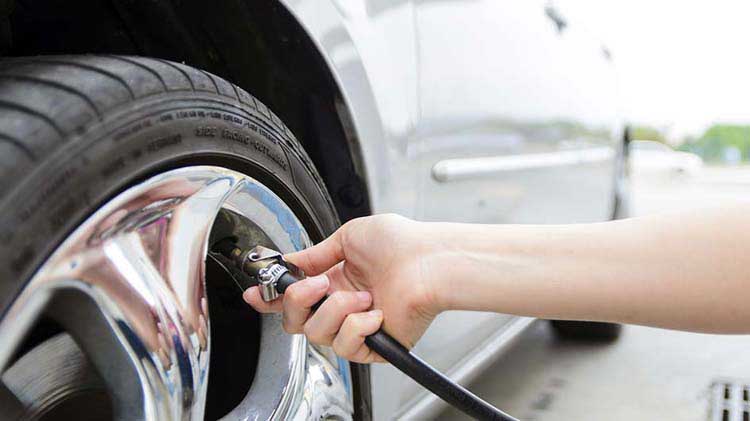 Women checking tire pressure